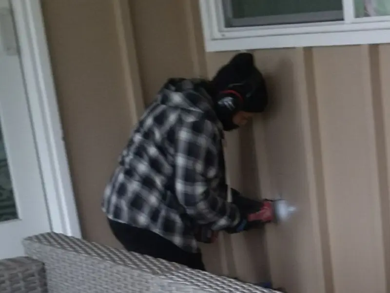 Professional electrician installing an exterior outlet in Pierson